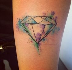 a watercolor style diamond tattoo on the leg