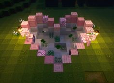 an aerial view of a pink house in the middle of a green field at night