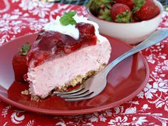 a piece of strawberry cheesecake on a red plate