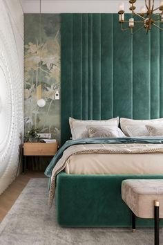 a bedroom with green velvet headboard and white bedding