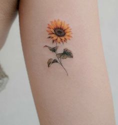 a small sunflower tattoo on the right thigh