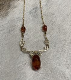 This stunning piece comes to us from Europe. The main Amber Stone is about 5/8 of inch long. The two smaller amber stones are approximately 1/4 inch long. The necklace is 14k and is approximately 17.5 inches in length. Pre-owned. Marked 585. Simply stunning and reminiscent of a by gone era. Layaway-All regular priced items can be placed on layaway with payment plans between 2 and 6 payments, depending on the cost of the piece. The 1st payment of the layaway is due on the day of the agreed layawa Brown Hair Inspo, Amber Necklace, Amber Stone, Wedding Jewellery Necklace, Wedding Necklace, Antique Style, Vintage Necklace, Hair Inspo, Brown Hair