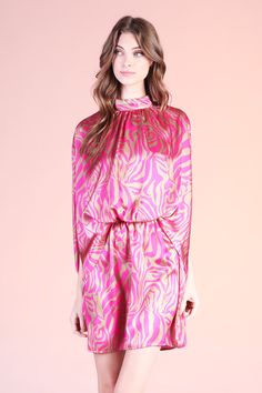 Add a little spice to your formal wear with our Frida Luxe Satin Mock Neck Caftan Mini Dress. This print is beautiful and gives the perfect touch of color to the closet. The dress pulls over the body and secures with a tie behind the neck. The waist is elastic to keep the body in place from day to night. Pair with minimal accessories and neutral shoes. SKU #: D-7931 Summer Evening Dresses With Tie Neck, Elegant Flowy Multicolor Mini Dress, Chic Floral Print Tie Neck Dress, Pink Fitted Dress With Elastic Neckline, Fitted Pink Dress With Elastic Neckline, Multicolor Party Dress With Tie Waist, Multicolor Tie Waist Dress For Party, Chic Party Dresses With Elastic Neckline, Chic Printed Tunic Dress