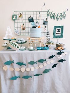 a table topped with a cake and desserts