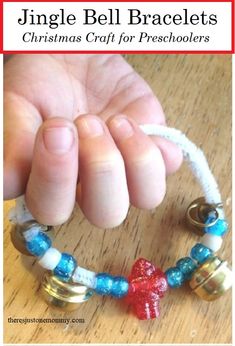 a hand holding onto a bracelet with bells on it and the words, jingle bell bracelets christmas craft for preschoolers