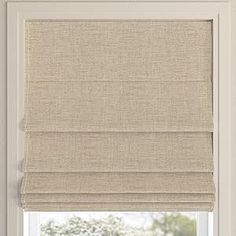 a beige roman blind in front of a window