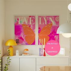 two paintings on the wall above a buffet table with candles and vases in front of it