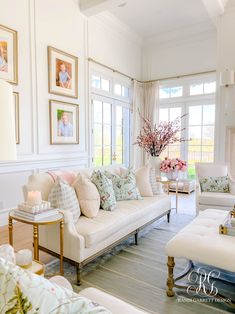 a living room filled with furniture and pictures on the wall