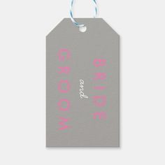 a gray and pink gift tag with the words bride and groom written in white on it