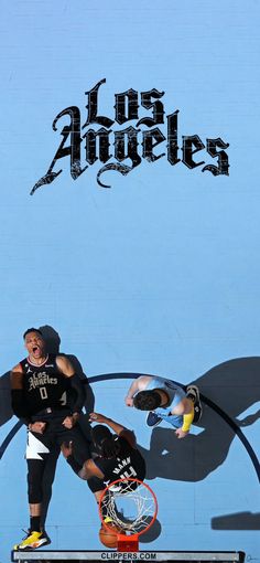 two men playing basketball in front of a blue wall with the words los angeles written on it