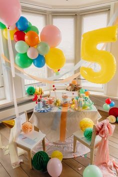 a birthday party with balloons and streamers