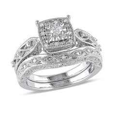 a wedding ring set with an intricate design on the band and center stone in white gold