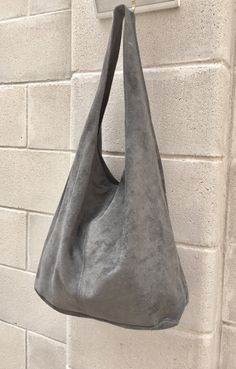 Suede slouch bag with ZIPPER. LARGE tote bag in gray. Natural genuine SUEDE bag. Soft leather HOBO bag in GRAY. Large enough to fit most laptops, tanlets, books etc. Comfortable to carry due to the wide soft suede strap. Laptop or book bag in genuine suede leather. NOT LINED. The bag is closed by a zipper at the top Width : 42cm - 16,5 in Height at the center: 34 cm - 13, 5 inc Total height : 65,5 cm - 26 inch This bag in different colors and other leather Bags by Good Times Barcelona: https://w Soft Leather Hobo Bag, Tote Leather Bag, Slouch Bag, Bohemian Bag, Suede Tote Bag, Slouch Bags, Suede Bag, Bohemian Bags, Suede Tote