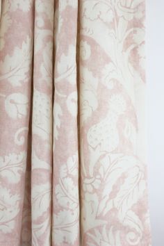 pink and white curtains with floral designs on them