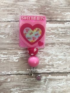 "Candy Sweethearts badge reel.  Badge reel is 1.5\" across and 3.5\" in length. All reels have alligator clip hardware. All images are sealed for durability. Easy to sanitize. All badge reels are handmade and might have slight variations. Badge reels are not meant for excessive weight (I.e. keys, scissors, multiple cards).  If your reel is not retracting properly please remove some weight." Valentines Badge Reel, Valentines Day Candy, Silicon Molds, Personalised Badges, Badge Holders Lanyard, Badge Reel, Alligator, Diy Ideas, Keychains