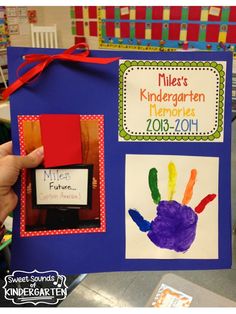 a child's handprinted book is held up in the classroom