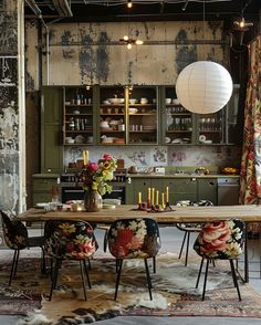 a dining room table surrounded by chairs with floral upholstering and hanging lights