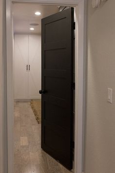 an open door leading to a hallway with white walls