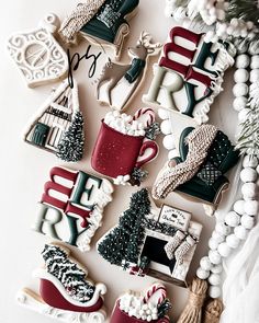 decorated cookies are arranged in the shape of christmas trees, stockings and sleighs