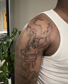 a man with a tattoo on his arm holding up a basketball ball in the air