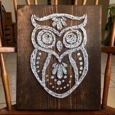 an owl painted on top of a wooden chair