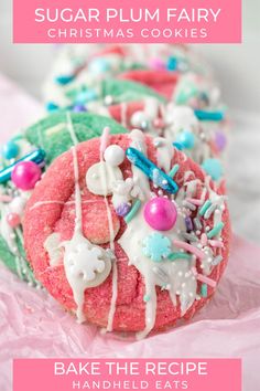 sugar plum fairy cookies with white icing and sprinkles on pink paper