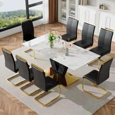 a marble dining table with black chairs around it