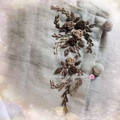 an embroidered piece of cloth with flowers on it