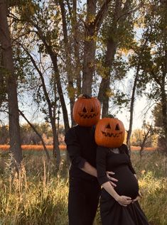 a pregnant couple dressed up as jack - o'- lanterns