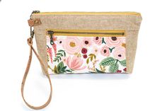 "This is a brand new make from my studio, perfect for warmer weather! This linen and cotton wristlet is lightweight and has two zippered sections to keep your things organized. It has a detachable cork wristlet strap that's eco friendly and durable. The exterior is a combination of linen with cotton floral. The linen adds great texture to the bag. The size of this wristlet is approximately 8.5\" wide by 5\" tall by 2\" deep at the base. The bottom corners are boxed, which gives this wristlet dep On-the-go Zipper Pouch Wristlet Clutch, On-the-go Wristlet Clutch With Zipper, Everyday Handheld Wristlet With Zipper Pouch, Spring Zipper Pouch Wristlet Clutch, Rectangular Wristlet For Spring Gift, Rectangular Wristlet As Spring Gift, Rectangular Wristlet Gift For Spring, Spring Pouch Wristlet With Zipper Closure, Everyday Wristlet With Zipper Pouch