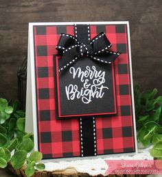 a red and black plaid card with a bow on the front that says merry and bright