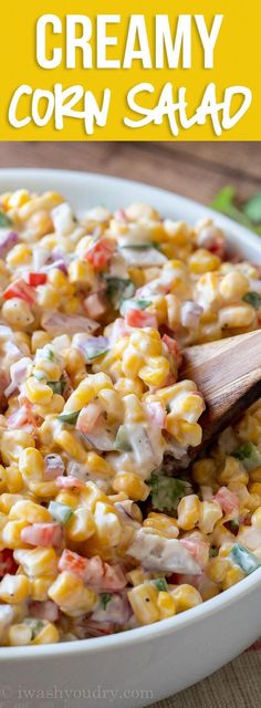 a white bowl filled with corn salad on top of a wooden table