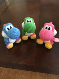 three stuffed animals sitting on top of a wooden table