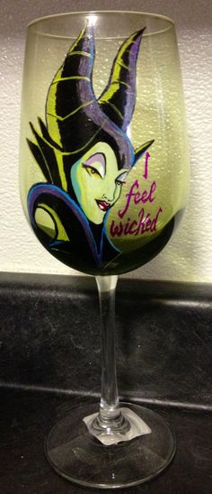 a wine glass with an image of a woman's face painted on it