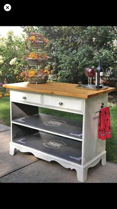 a kitchen island made out of an old dresser with drawers and shelves on the top