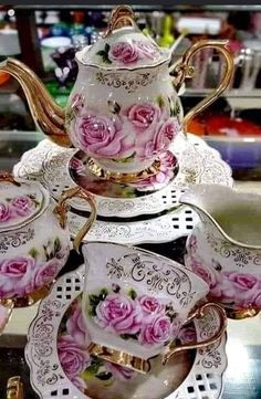 a tea set with pink roses on it