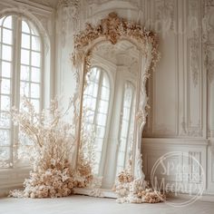 an ornately decorated mirror sitting on top of a floor in front of two windows