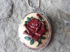 Beautiful cameo locket!!!  The cameo is a gorgeous flawless rose with a single bud, each cameo is individually hand painted, each an original!!!  The silver plated or bronze locket is victorian style with beautiful etching on both the front and back, 2" long, the last two photos are for sizing not color.  It can hold two photos and/or a treasured keepsake!!! Pass down from generation to generation!!! The bronze locket comes with a matching 24" rolo link chain (lead and nickel free), and the silv