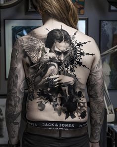 the back of a man with tattoos on his body