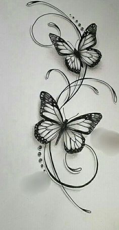 two butterflies are flying next to each other on a white surface and one is drawn with black ink