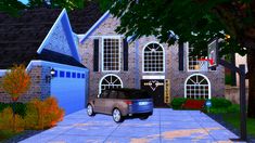 a car is parked in front of a large brick house with two garages on each side