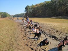 some people are playing in the mud and water