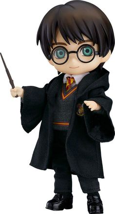 the harry potter doll is holding a wand and wearing a black suit with green eyes