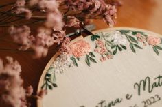 a close up of a embroidery on a table with flowers