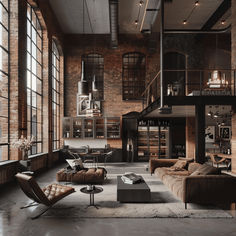 an industrial living room with brick walls and large windows, leather couches and chairs