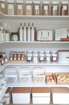 an organized pantry with lots of food and containers on the shelves in front of it