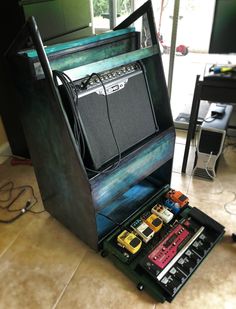 an old amp sitting on top of a table next to other musical instruments and pedals