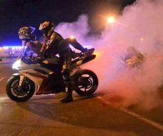 a man riding on the back of a white motorcycle