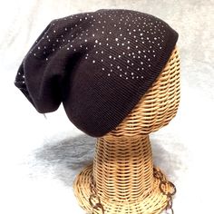 a knitted hat on top of a wicker mannequin's head