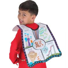 a young boy wearing a bib with pictures on it